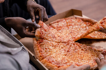 Group of friends eating pizza