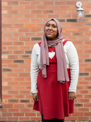 Portrait of woman wearing red dress and hijab