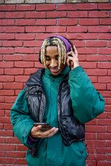Naklejka premium Smiling young man listening to music