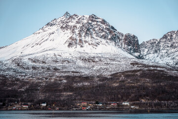 Snowy mountains and houses on coast, Tromso, Norway