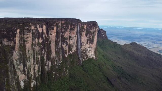 Impressive cinematic aerial view of huge waterfall in Roraima Tepui in Canaima National Park