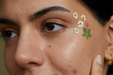 Close-up of young woman face decorated with dried flowers - obrazy, fototapety, plakaty