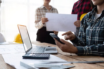 engineer working in office, engineer and architect use calculator for calculate drawing design construction, engineer discussion and estimate the cost of project
