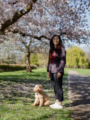 Portrait of smiling woman with dog in park