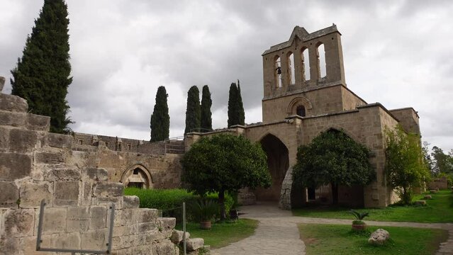 Walking towards church of the beautiful Bellapais Monastery, religion and historic architecture in Northern Cyprus