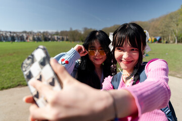 Young women taking selfie in park