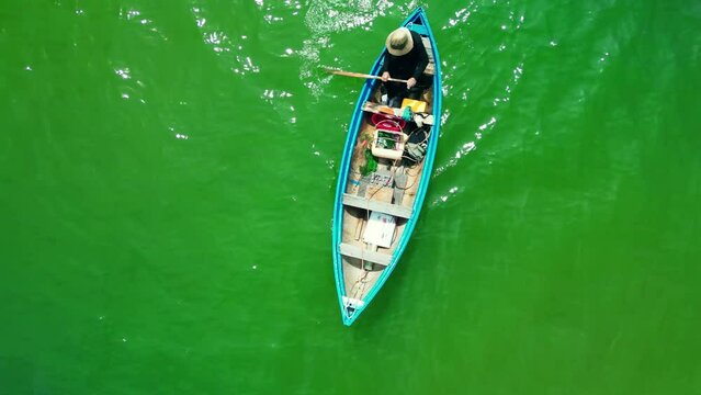 Top view asian fishing boat. Fisherman come out of the boat bay. On a sunny morning, a fishing boat hurries out to sea for a catch of seafood. The fisherman in Vietnam. 4K