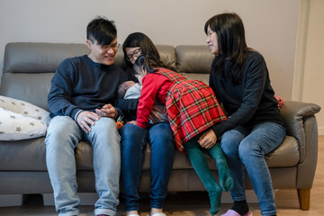 Two generation family with two children (0-1 months), (4-5) in living room