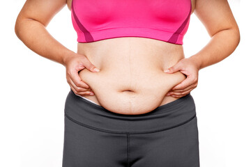 Woman touching his fat belly on white background. Woman hand holding excessive belly fat