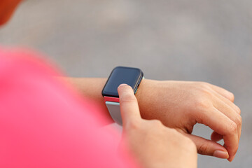 Woman hands setting smart watch. Technology and people concept