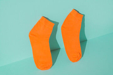 Orange socks new on the mint green background