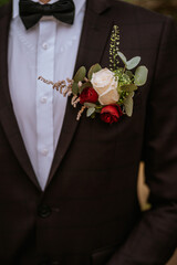 Beautifil tender buttonhole on grooms jacket. Close-up
