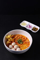 Khao Soi Thai Curry soup isolated in black background