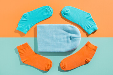 blue hat with new socks. teal orange split background