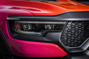 Fototapeta premium Mock-up, banner for car advertising. Red new car front view: xenon headlight, side mirror, bumper and hood