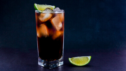 Cuba Libre drink on black background with copy space