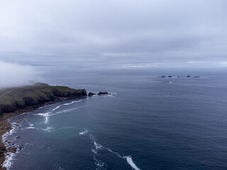 Fototapeta na wymiar Lighthouse off the coast of landsend aerial drone from the air. 