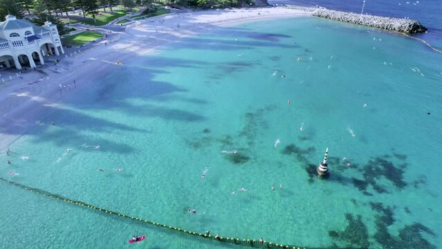 An aerial shot of Cottesloe Beach, Perth Western Australia. Swimmers can be seen training for the rottnest swim in the shark net.