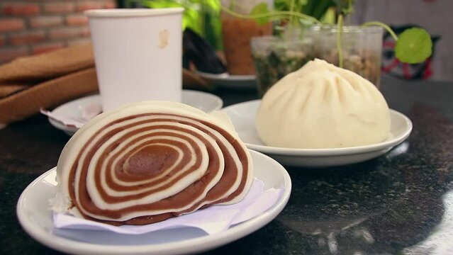 Chocolate Nom pao or bao, traditional khmer or cambodian dessert served at a cafe on a relaxing summer afternoon