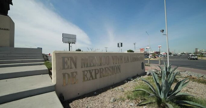 Sign that says "En Mexico vive la libertad de expresi&oacute;n" from a monument of the mexican ex-president Francisco Zarco in the middle of a roundabount in the city of Mexicali