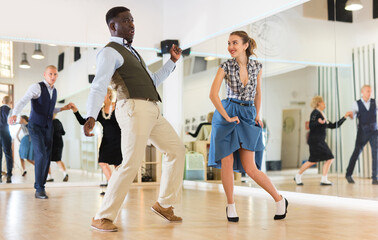 Fototapeta na wymiar Woman and man dancing swing in studio