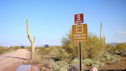 Sign in United States desert recreational park prohibiting firearm shooting