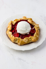 Mini biscuit with strawberries and a ball of ice cream. Delicious berry pie on a white background