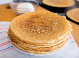 stack of appetizing flour pancakes in the kitchen during cooking