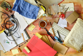 messy and clutterd office workplace, overworked, red tape, bureaucracy, business concept, flat lay with various office supplies