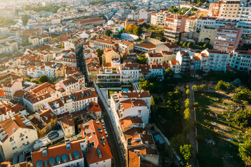 Obraz premium Aerial drone view of apeople at two viewpoints overlooking Lisbon, Portugal at sunset