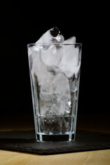 Glass with ice for an alcoholic cocktail, close-up