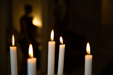 Mysterious and spooky figure behind the candle lights