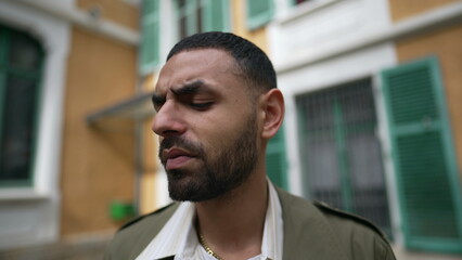Closeup face of an Arab man with thoughtful expression. A Pensive male person standing outside in...