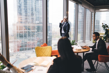 Group of multiethnic coworkers working on project in modern workspace