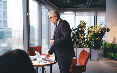 Pensive senior businessman working in office