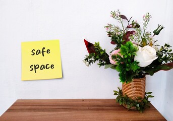 Welcome wall with handwritten text SAFE SPACE, places where people can feel confident - free of...