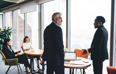 Diverse colleagues working on project in office cafeteria