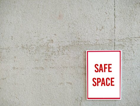 Copy space empty wall with sign SAFE SPACE, places where people can feel confident - free of bias, conflict, criticism or discrimination, no emotional or physical harm