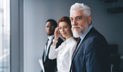 Group of cheerful diverse businesspeople standing and looking at camera