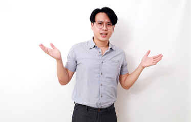 Asian man standing with confused gesture and expression. Isolated on white