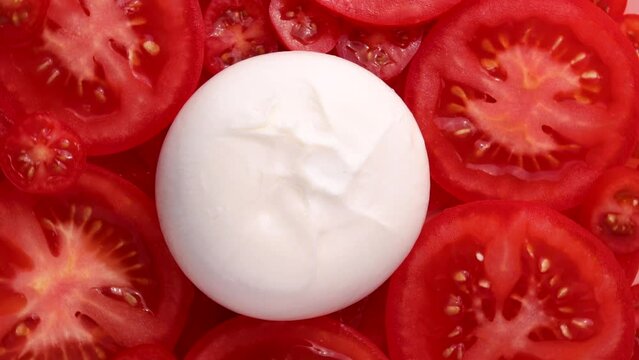 tomato, rotation in circle. Burrata cheese and tomato slices. tomato background. Italian Food Turning. selective focus.