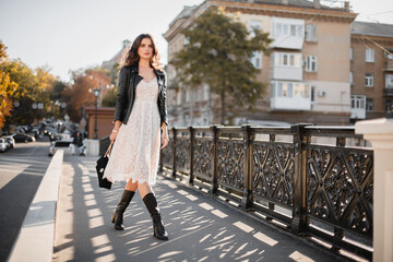 attractive woman walking in street in fashionable outfit