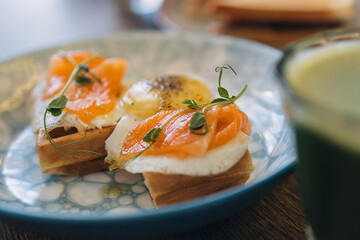 Waffles with egg, salmon and microgreens.Delicious and healthy breakfast food concept.Close-up,selective focus.