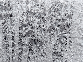 frost pattern on window glass closeup on cold winter day