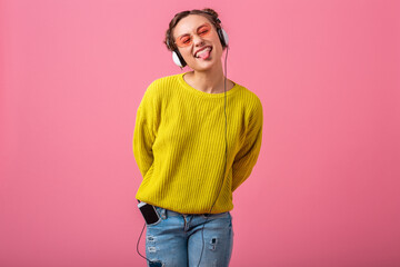 attractive woman in cheerful exited mood listening to music in headphones