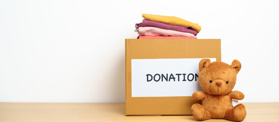 Kid Donation, Charity, Volunteer, Giving and Delivery Concept. Bear doll and Clothes with Donation...