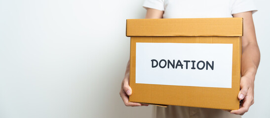 Donation, Charity, Volunteer, Giving and Delivery Concept. People donate Clothes and Food into Donation box at home or office for support and help poor, refugee and homeless people. Copy space