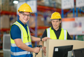 A male manager is checking inventory inside a warehouse.