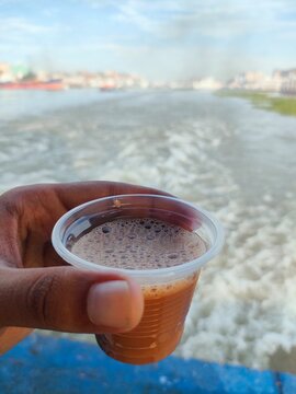 A hand holding a cup of tea