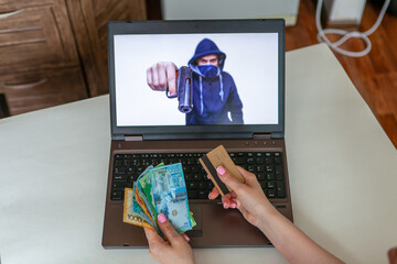 
Theft through a laptop. The robber threatens with a weapon from a laptop. A woman gives money and...